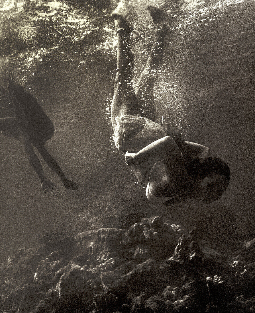 USA, Hawaii, women swimming underwater, Kealakekua Bay, The Big Island (B&W)