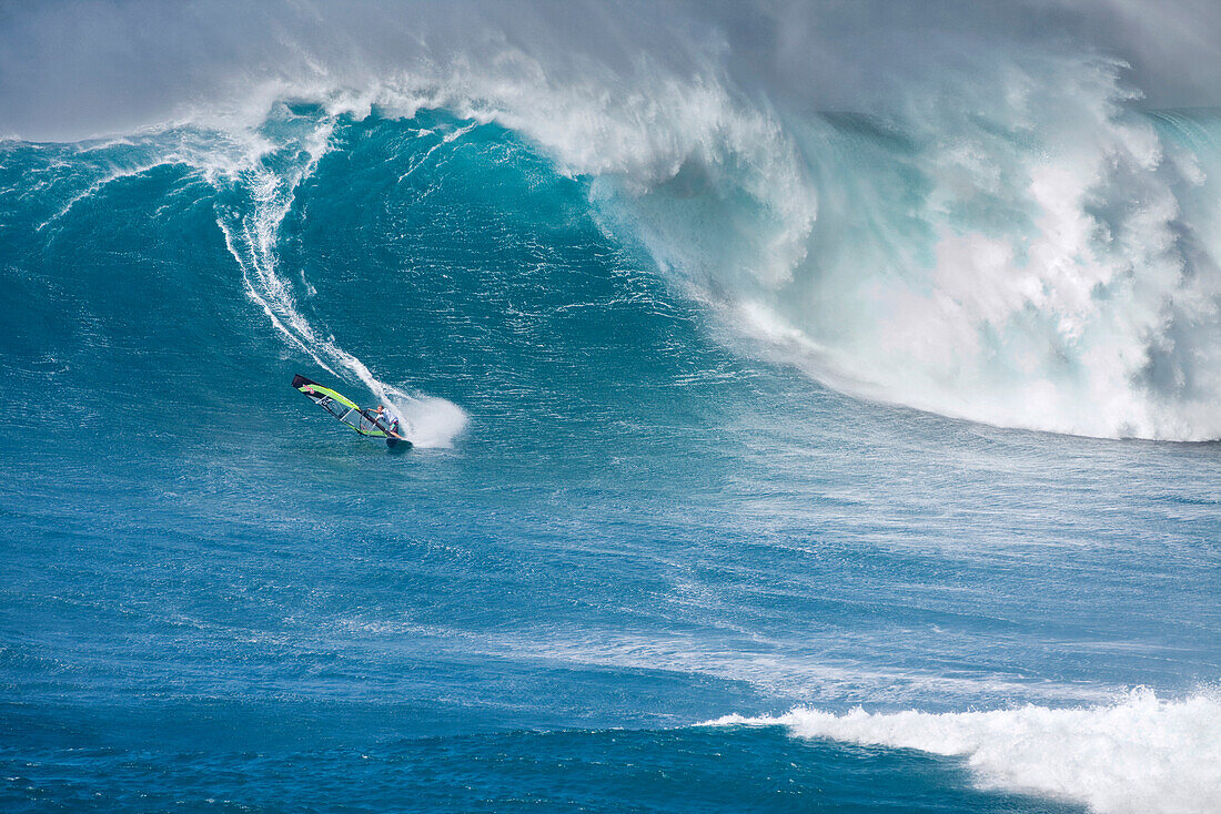 USA, Hawaii, Maui, a man windsurfs on huge waves at a break called Jaws or Peahi