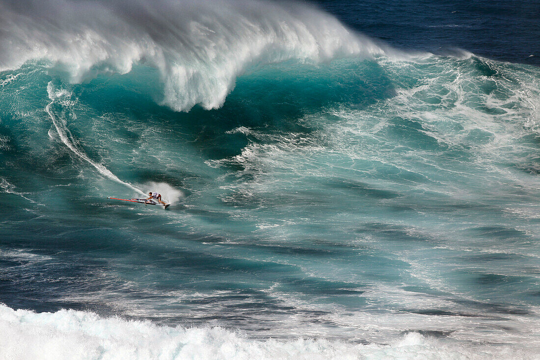 USA, Hawaii, Maui, a man windsurfs on huge waves at a break called Jaws or Peahi