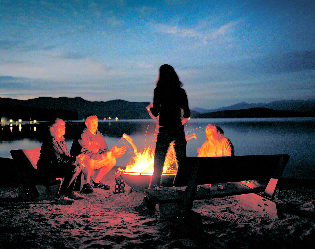 USA, Idaho, family around a beach bonfire, Priest Lake