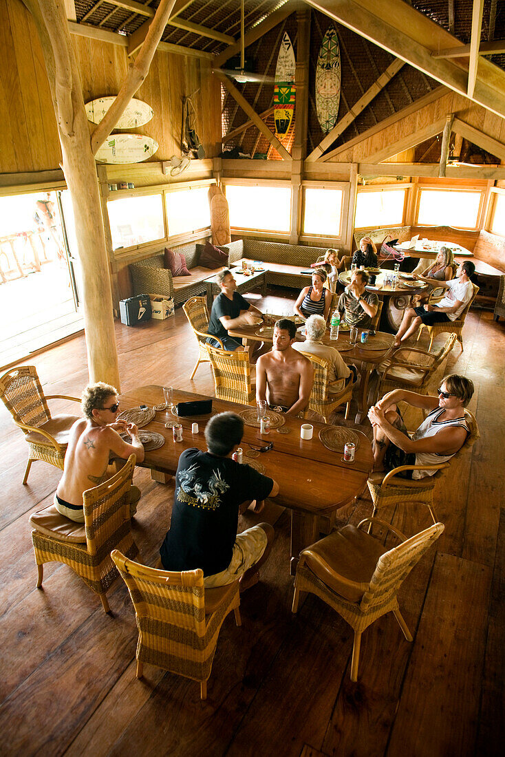 INDONESIA, Mentawai Islands, Kandui Resort, people having breakfast in a dining lodge