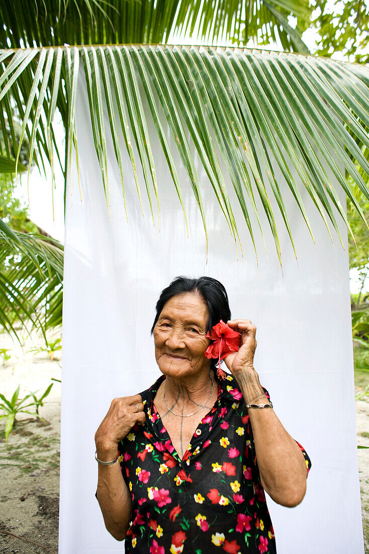 INDONESIA, Mentawai Islands, Kandui Resort, portrait of a smiling Mentawai elder with tattos named Tatiana