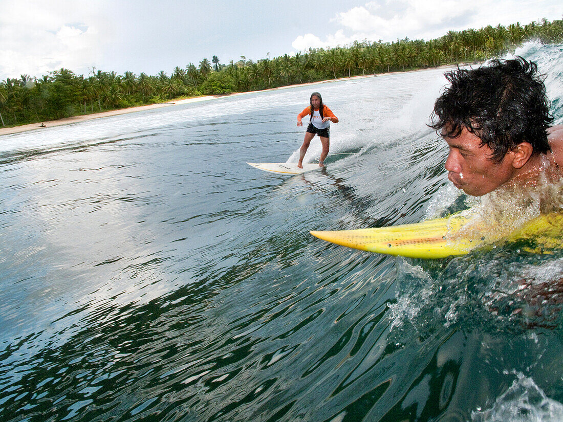 INDONESIA, Mentawai Islands, surfing a wave at Beng Beng
