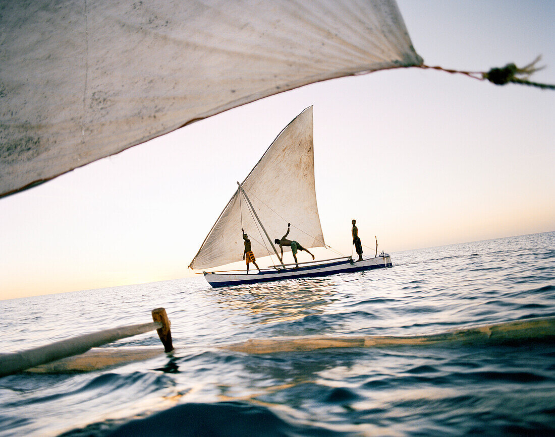 MADAGASCAR, three men sailing in pirogue, Mozambique Channel, Anjajavy
