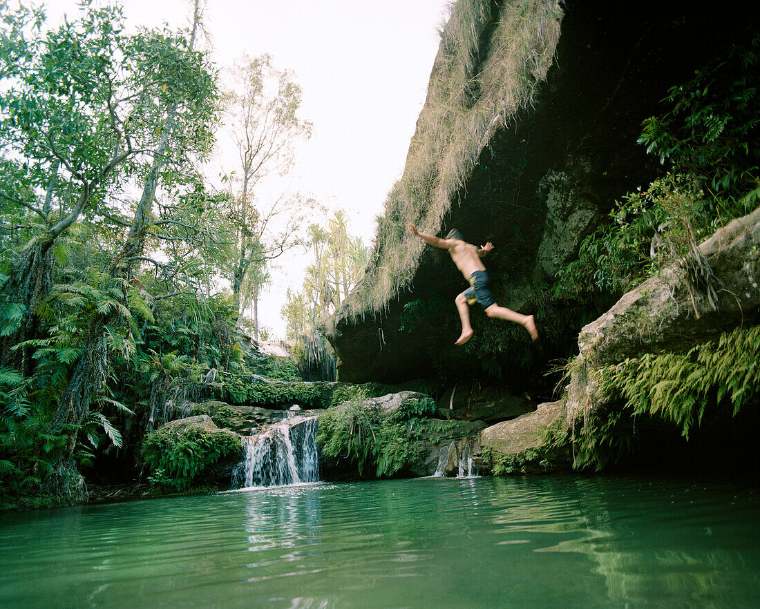Madagascar, man jumping into pool, Isalo National Park