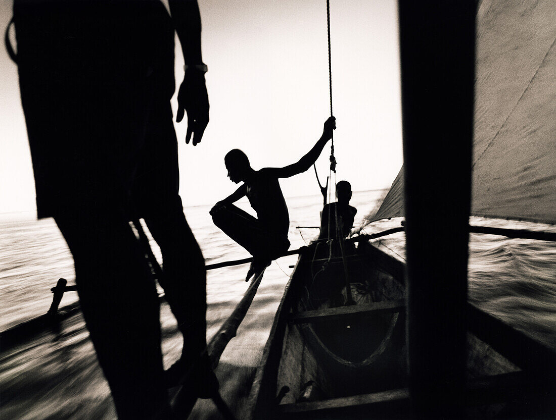 MADAGASCAR, Anjajavy, fisherman in pirogue sailing back to their village at the end of the day