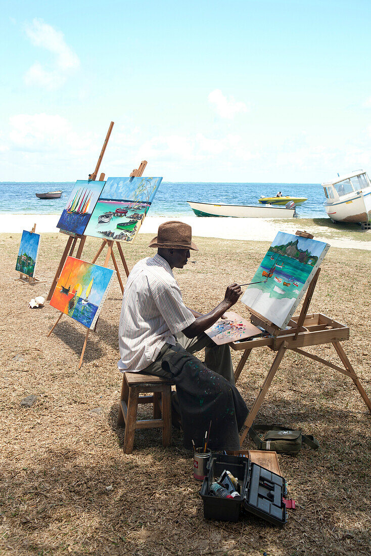 MAURITIUS, an artist creates and sells his paintings by the water in Trou du D'eau