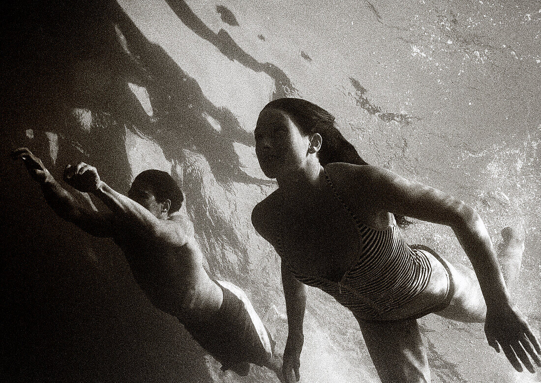 MEXICO, Baja, man and woman swimming in the Pacific, Cabo San Lucas (B&W)