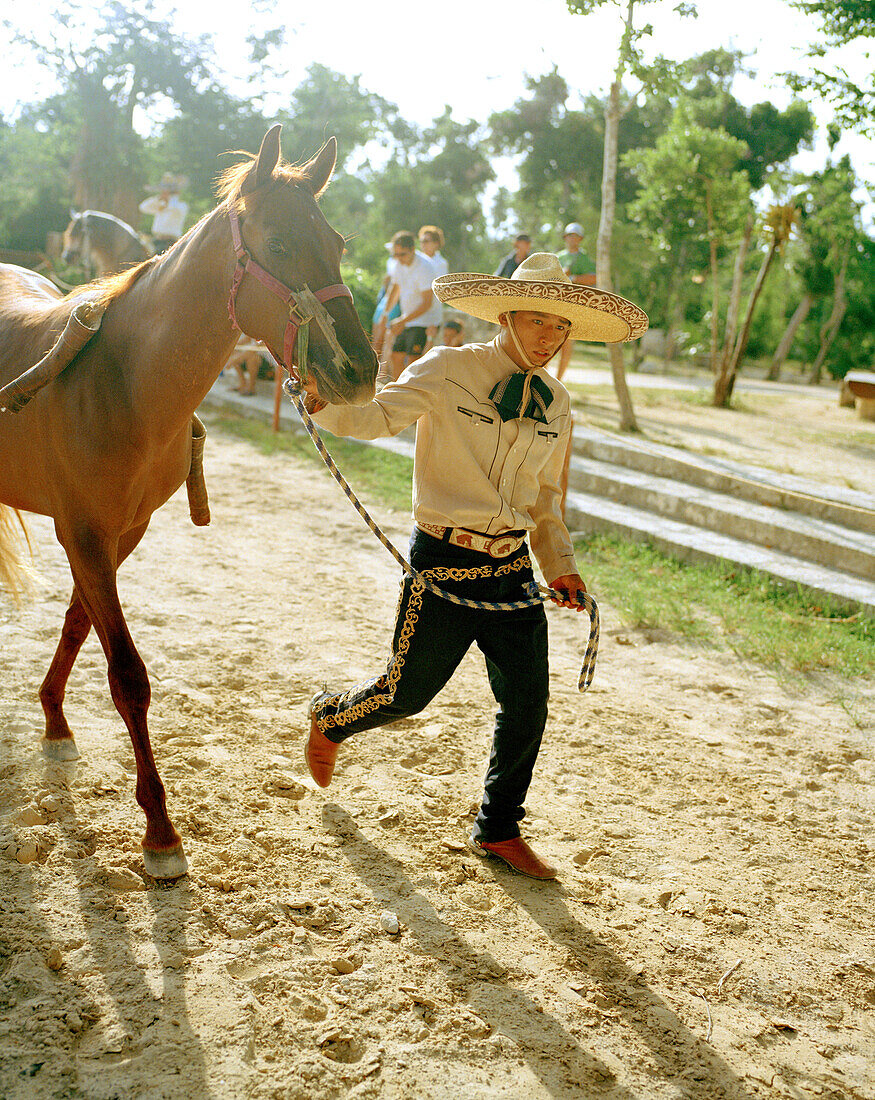 MEXICO, Maya Riviera, Mexican Cowboy leading his horse, Yucatan Peninsula