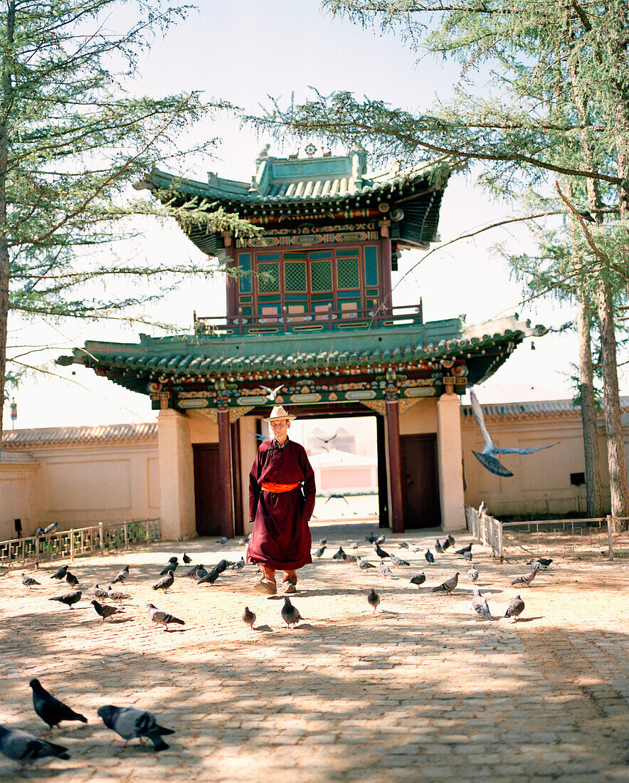 MONGOLIA, monk walking in Gandan Monastery