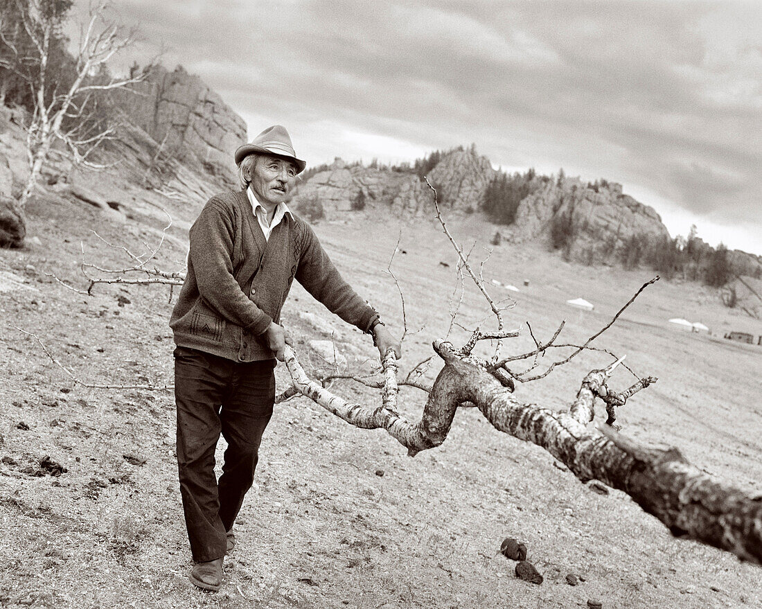 MONGOLIA, Gorkhi-Terelj, farmer carries firewood to his home, Gorkhi-Terelj National Park (B&W)