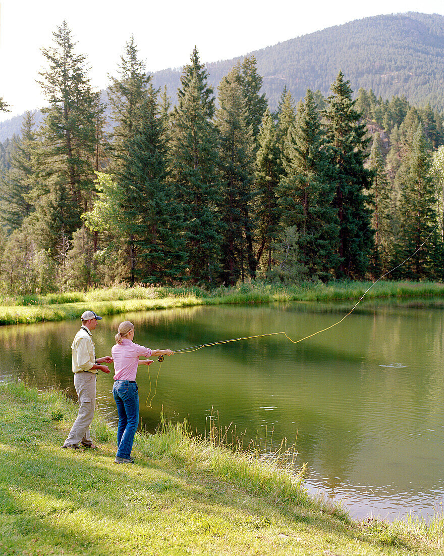 USA, Montana, woman fly fishing for … – License image – 70434822 ❘  lookphotos