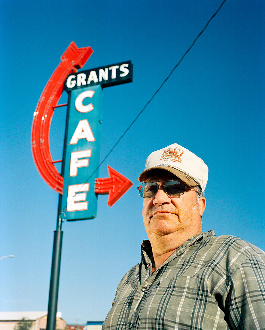USA, New Mexico, truck driver standing under Grants Cafe sign, Grants