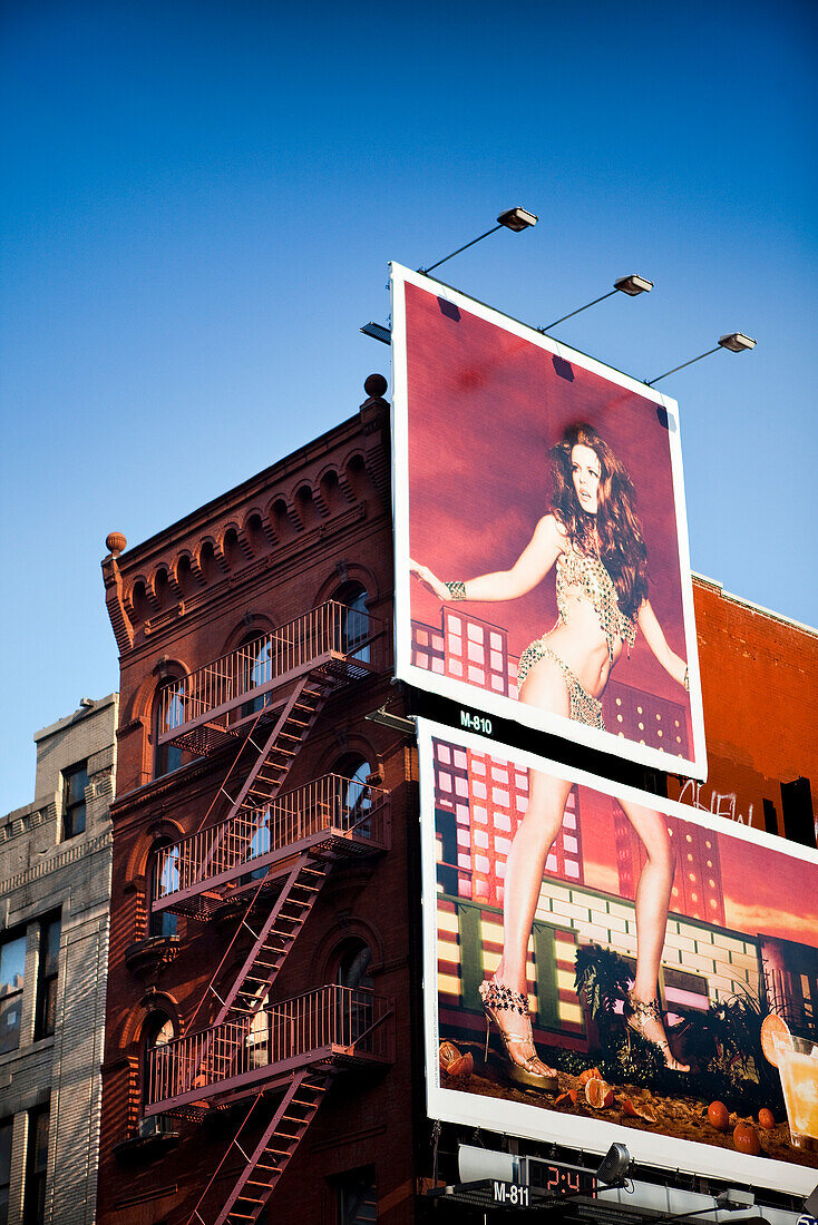 USA, New York, a red building in Soho with a billboard of a beautiful woman, New York City
