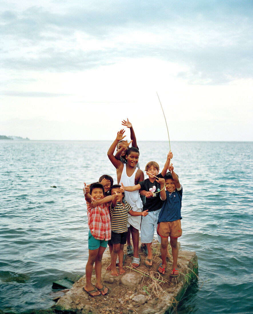 PANAMA, boys on the rocks, Caribbean Sea, Bocas del Toro