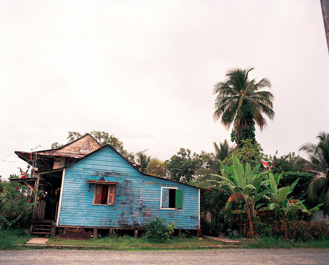 PANAMA, Bocas del Toro, a vibrantly colored run down home in town, Central America