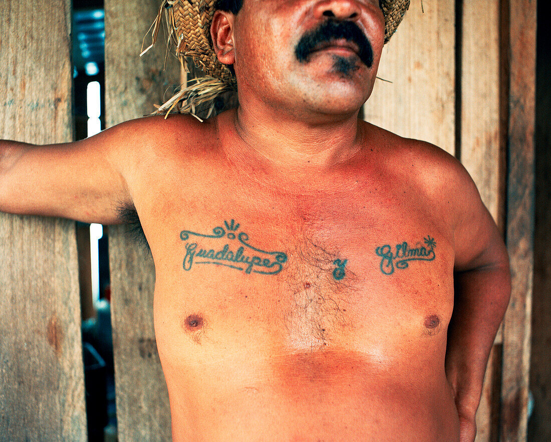 PANAMA, Bocas del Toro, a local man is tattooed with the names of his mother and wife, Central America