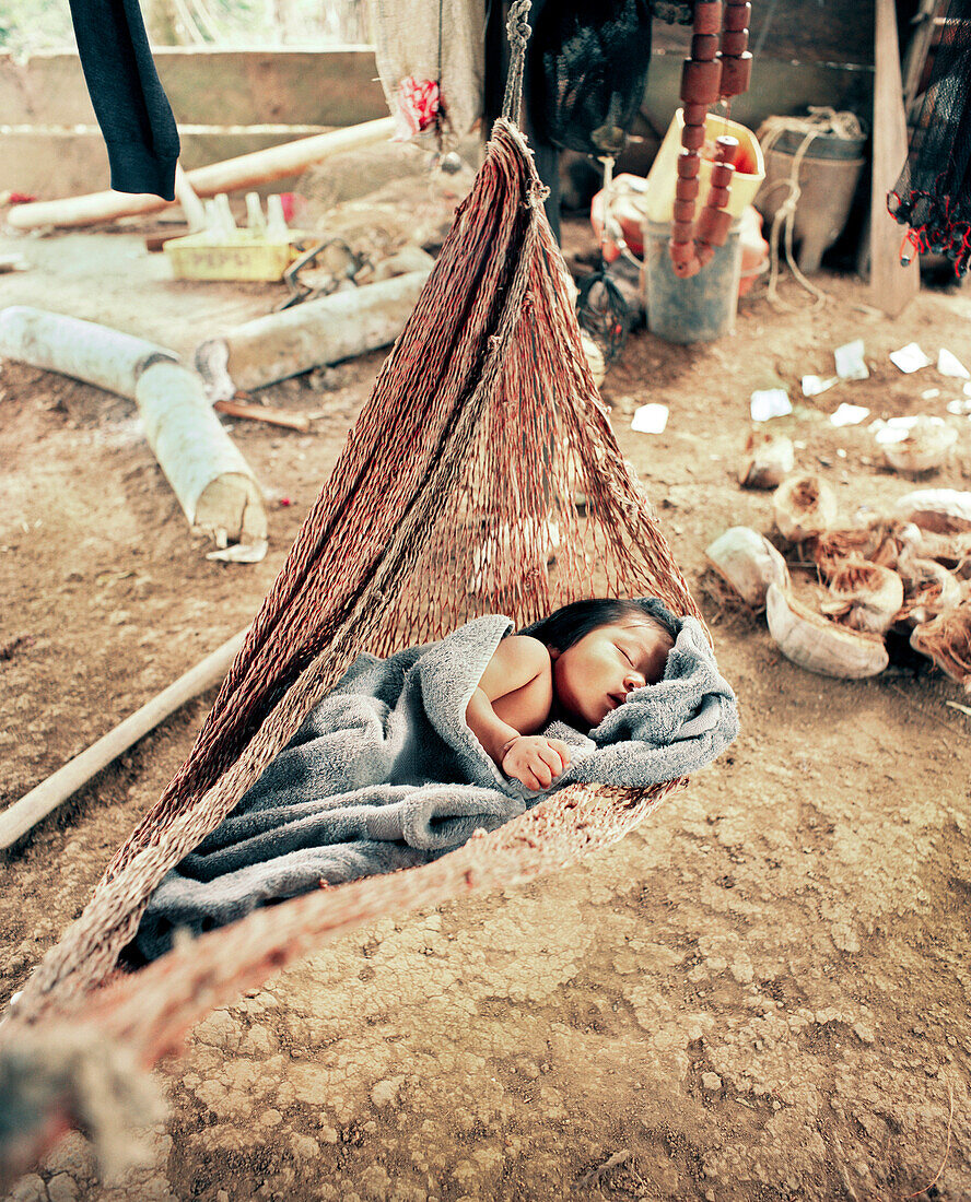 PANAMA, Bocas del Toro, Salt Creek Islands, a Guaymi Indian baby sleeps in a hammock, Central America