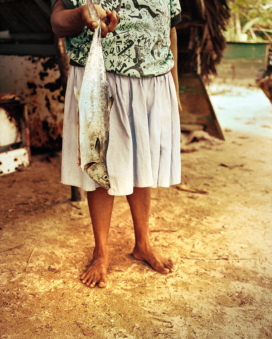 PANAMA, Isla Bastimentos, a woman gets ready to prepare a fish dinner, Central America