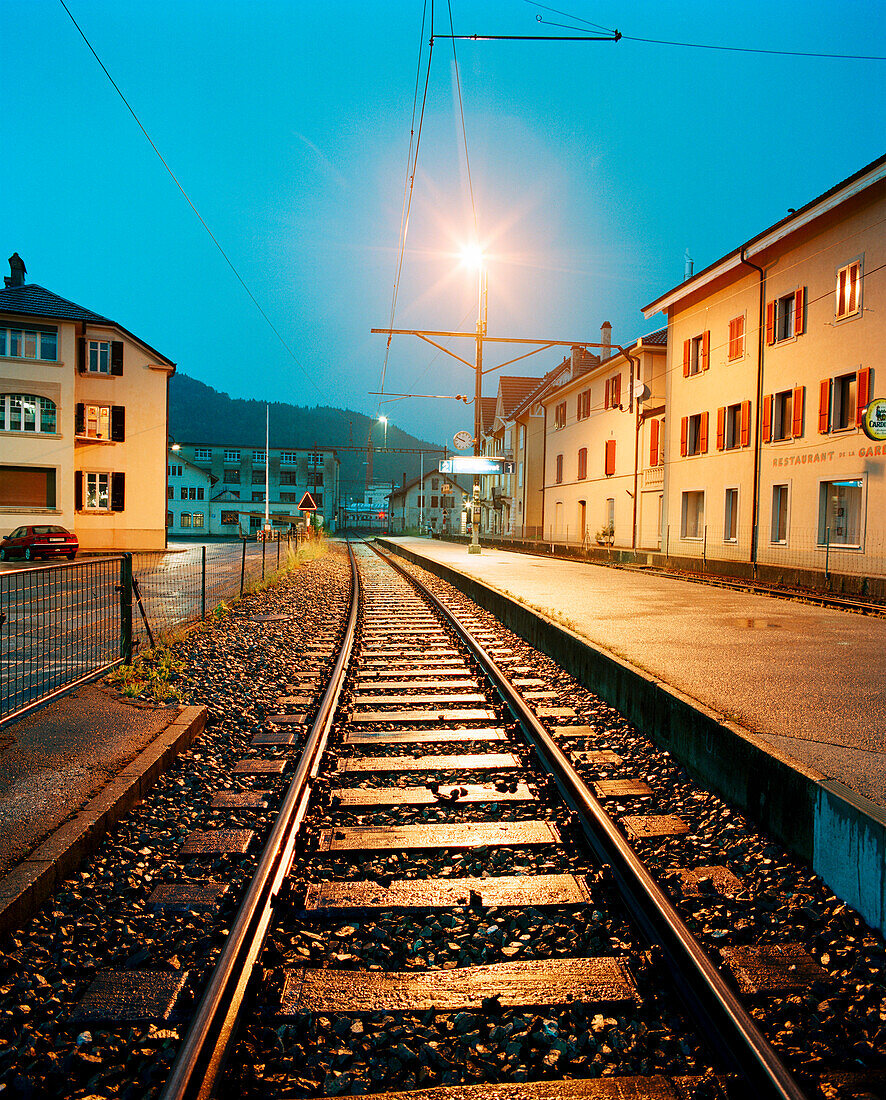 SWITZERLAND, Couvet, the train station at dusk, Jura Region