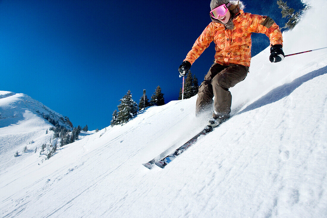 USA, Utah, young woman skiing Lee's Tree, Alta Ski Resort