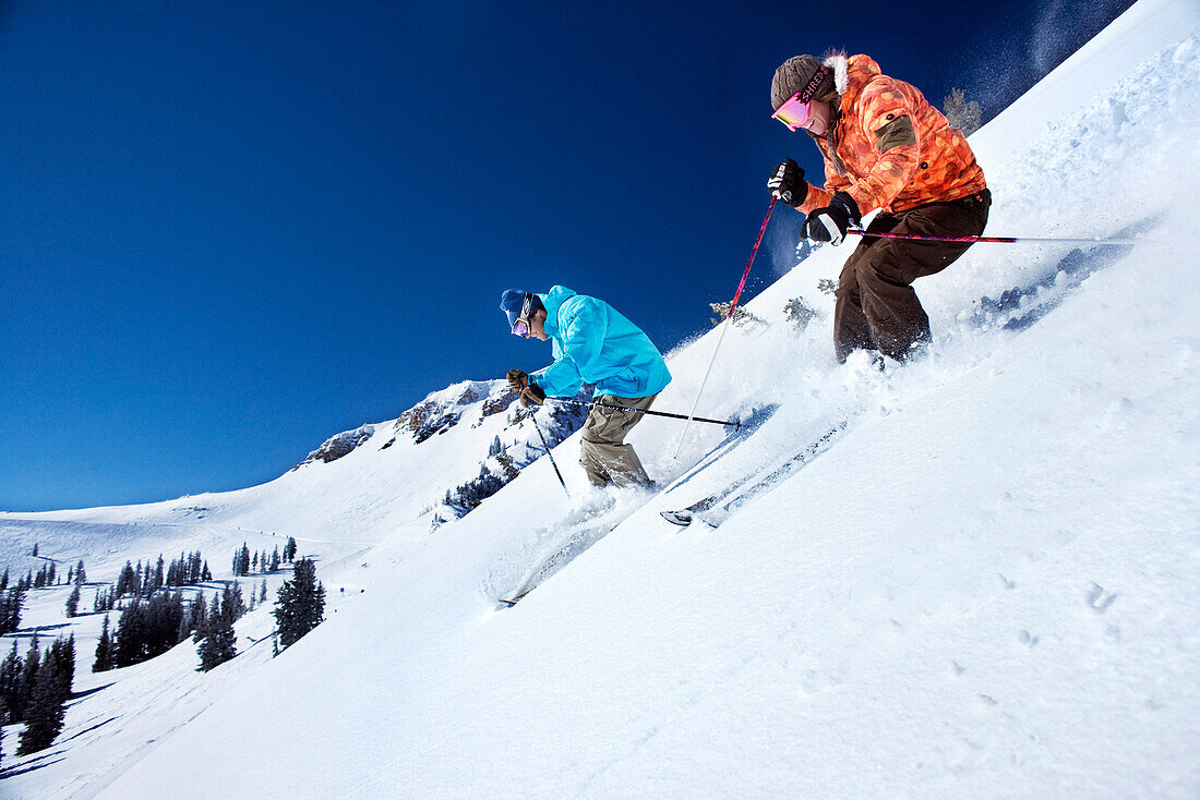 USA, Utah, man and woman skiing together in the Yellow Trail Area, Alta Ski Resort