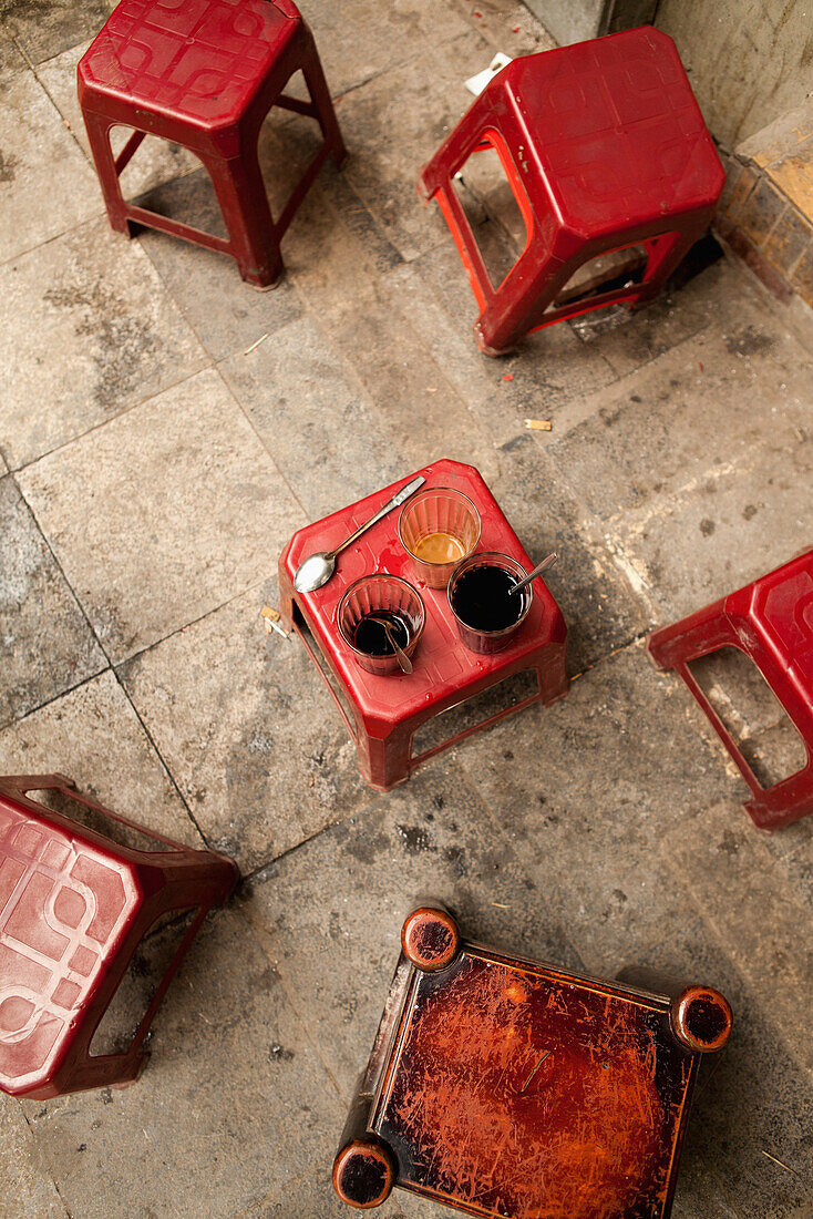 VIETNAM, Hanoi, small stools on the sidewalk in front of Cafe Nang coffee shop in the Old quarter