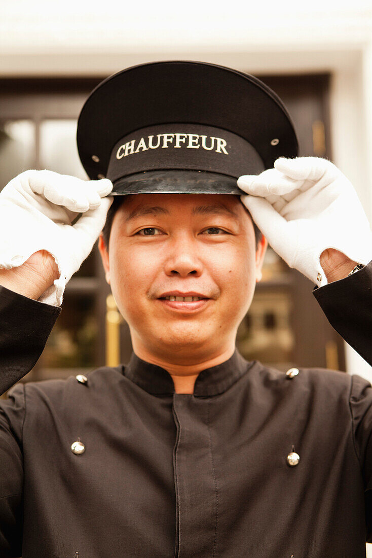 VIETNAM, Hanoi, Sofitel Metropole Hotel, one of the hotel chauffeurs in front of the hotel