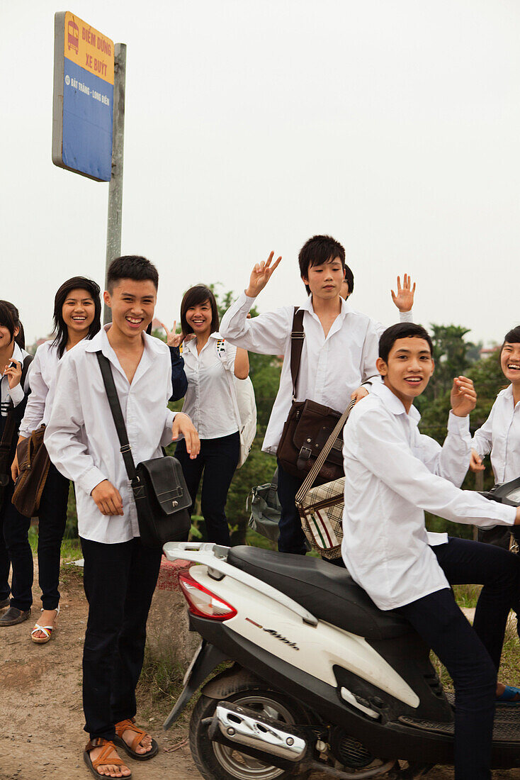 VIETNAM, Hanoi, Bathranag Village, school kids waiting for a bus at the end of the day