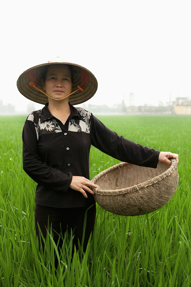 VIETNAM, Hanoi countryside, portrait of rice farmer Nguyen Thi Ha in her rice field, Nguyen Huu Y village