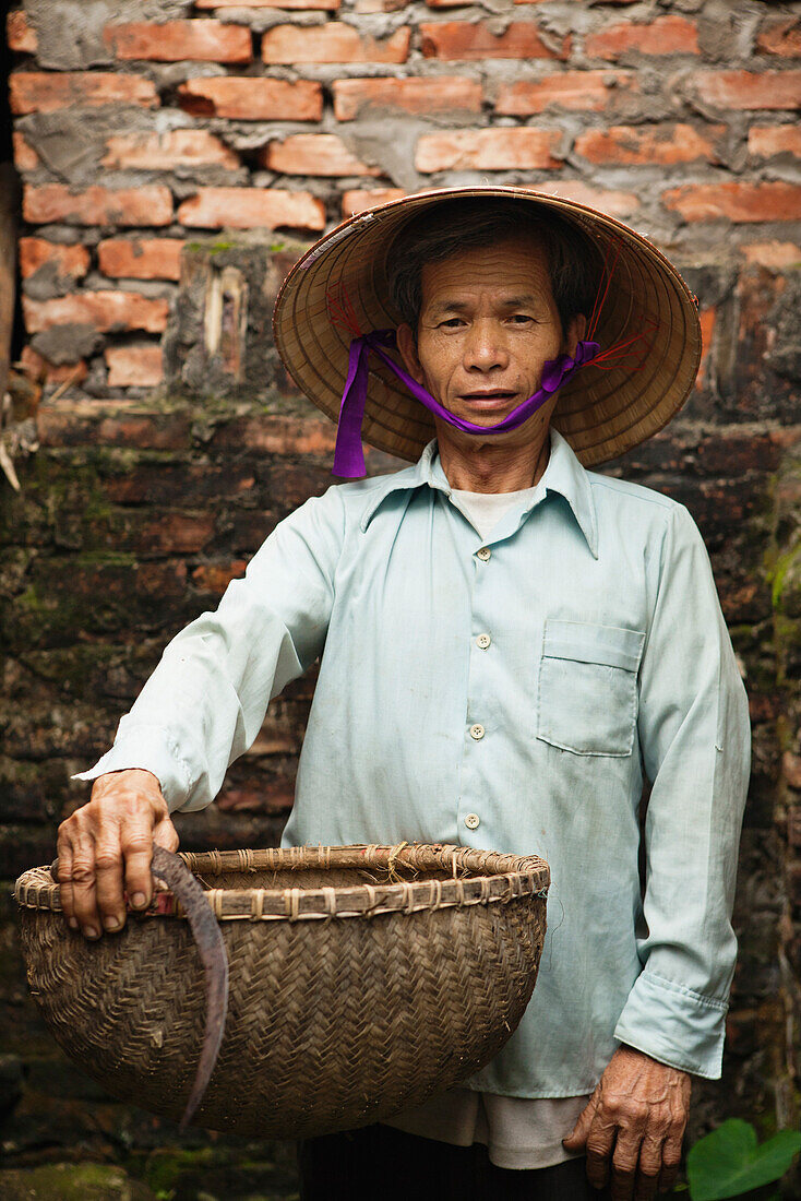 VIETNAM, Hanoi countryside, portrait of rice farmer Nguyen Huu Uc at his home in Nguyen Huu Y village