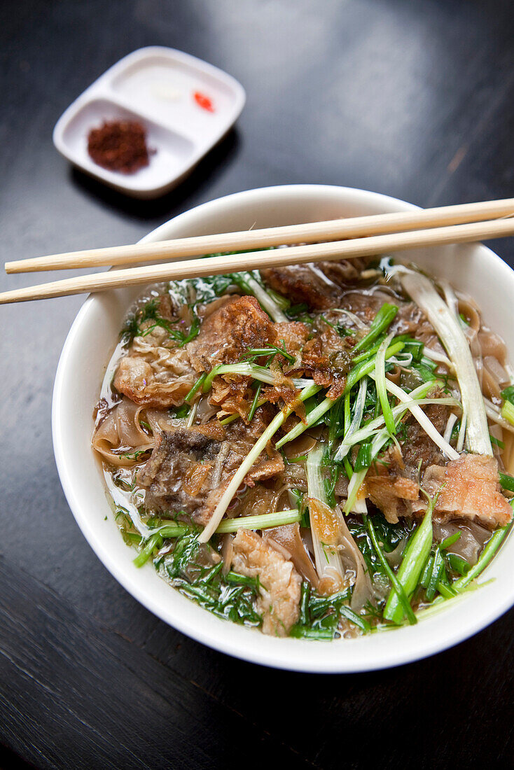 VIETNAM, Hanoi, traditional street food restaurant called Quan An Ngon, Beef Noodle bowl, Banh Ota Ca