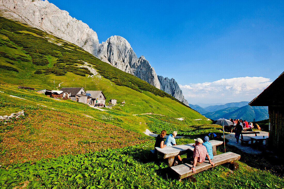 Hikers resting at an alpine lodge, Foelzalm, Styria, Austria