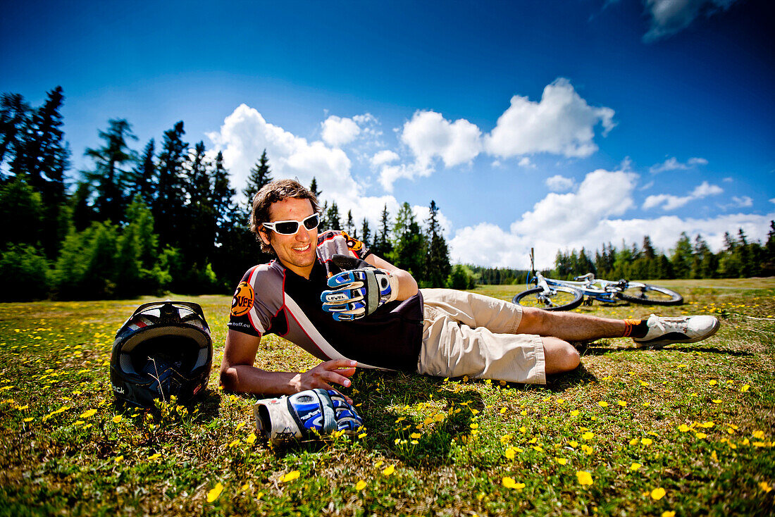 Downhill mountain biker resting, Frauenalpe, Murau, Styria, Austria