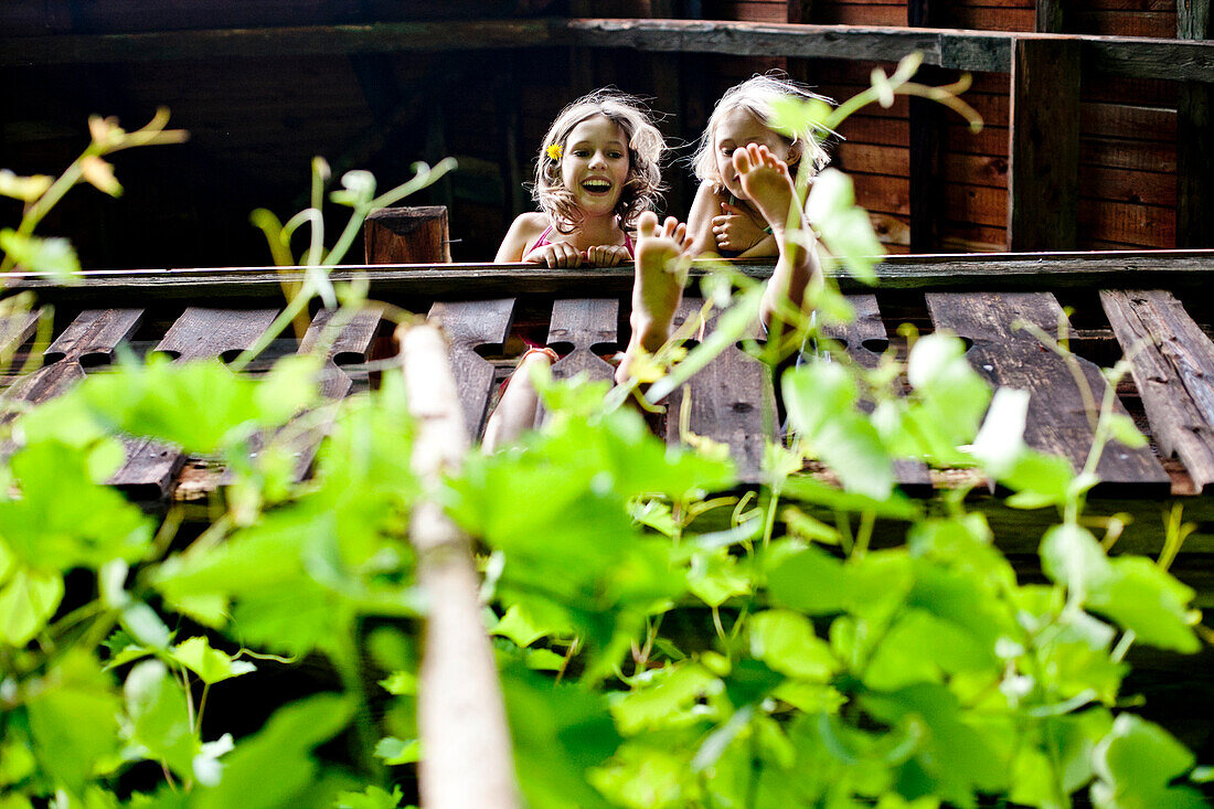 Two girls standing on a balcony, Styria, Austria