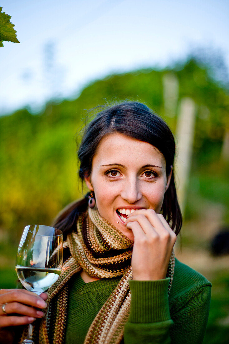 Young woman holding a glass of white wine, Spielfeld, Styria, Austria