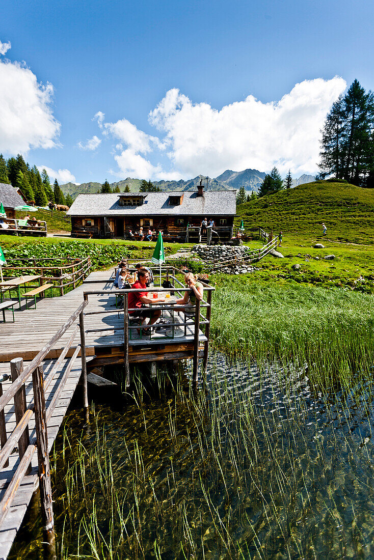 Guests on sun terrace near Duisitzkarsee lodge, lake Duisitzkar, Styria, Austria