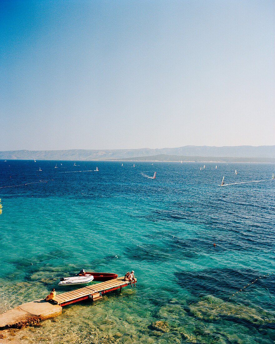 CROATIA, Bol, Brac, Dalmatian Coast, Island, elevated view of Dalmatian coast and windsurfers in the background.