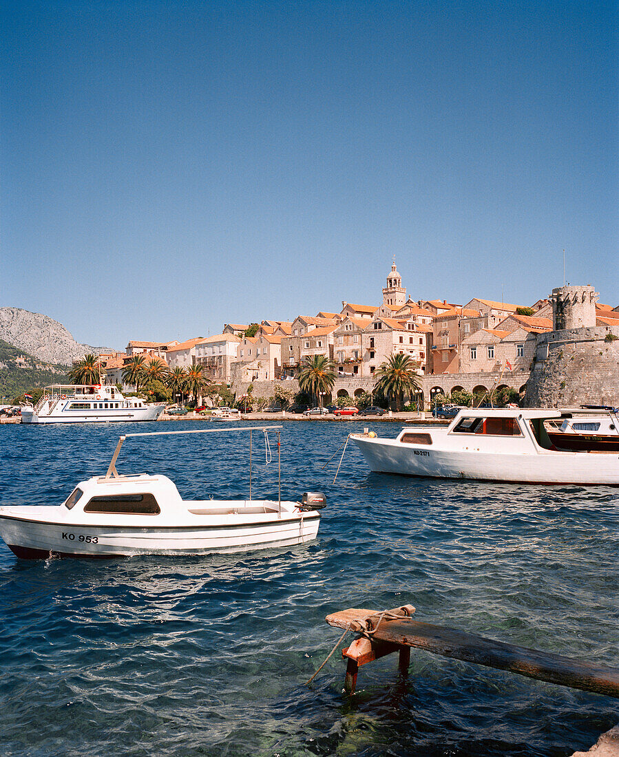 CROATIA, Korcula, Dalmatian Coast, Island, boat moored at Korcula Island with buildings in the background