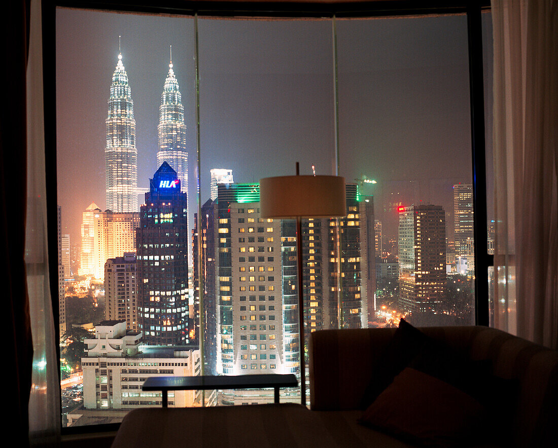 MALAYSIA, Asia, Kuala Lumpur, hotel view of Petronas Towers and downtown Kuala Lumpur at night.