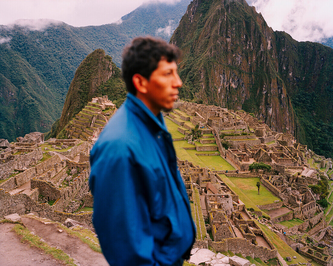 PERU, Machu Picchu, South America, Latin America, side view of a man with Machu Picchu in the background.