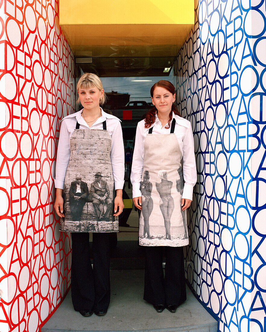 RUSSIA, Moscow, young waitresses at the front door of the Book Cafe.
