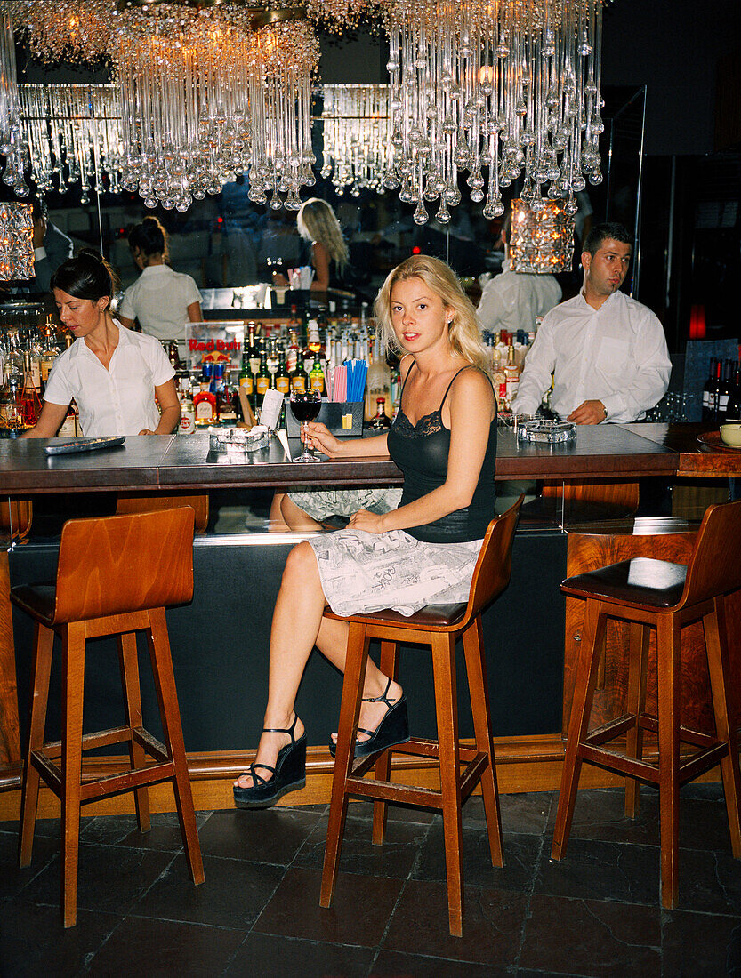 TURKEY, Istanbul, portrait of young female sitting at bar counter in Ulus 29 Restaurant