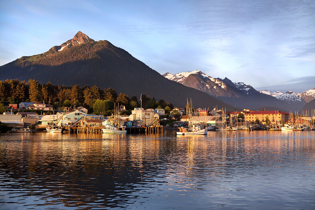 ALASKA, Sitka, a peaceful view of homes and fishing boats along the shore in Sitka Harbor at sunset, Crescent Bay