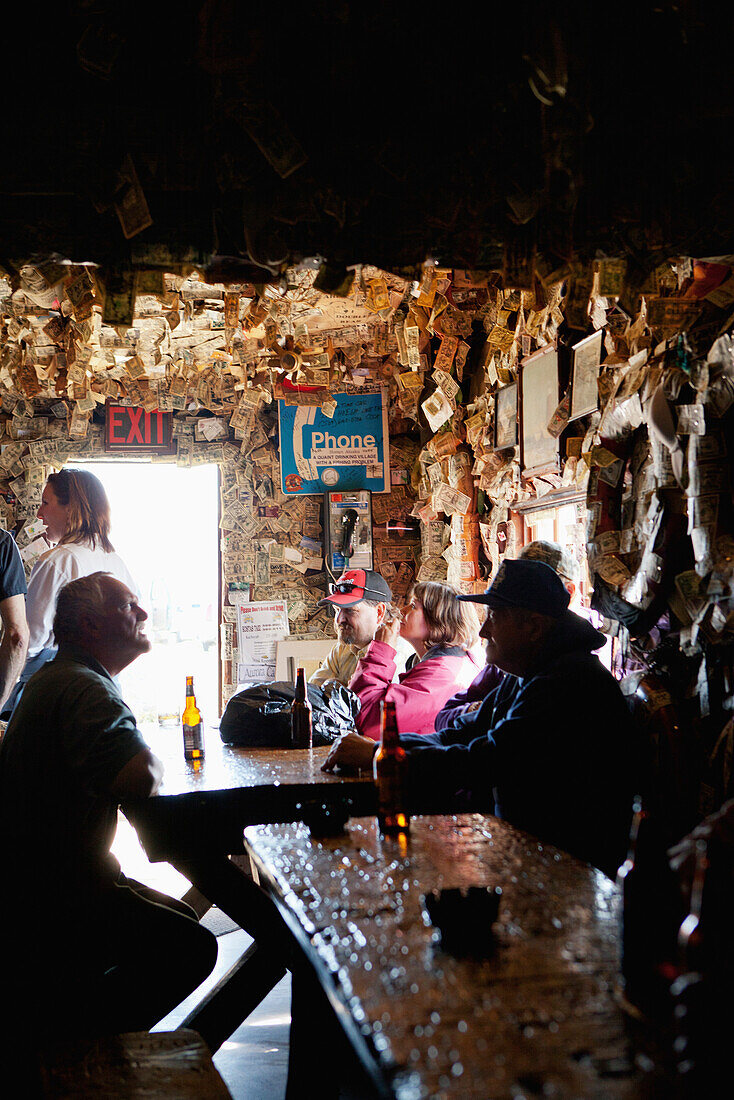 ALASKA, Homer, fishermen drink beer at the Salty Dawg Saloon after a long day of fishing, Land's End, the Homer Spit