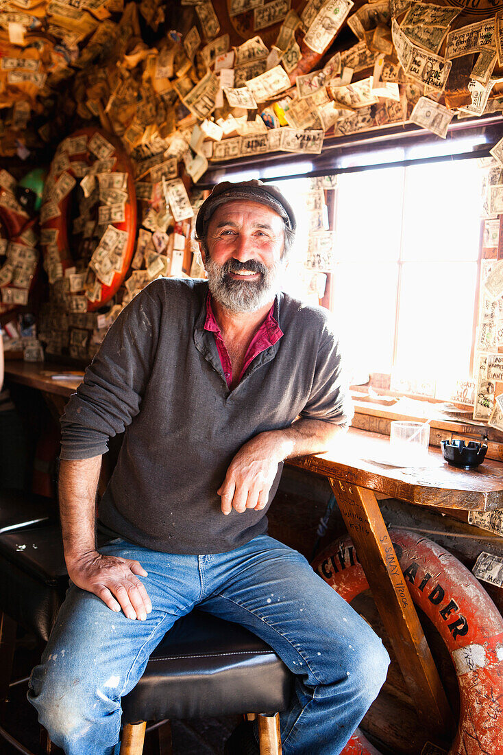 ALASKA, Homer, portrait of a fisherman Albert Arakelaine at the Salty Dawg Saloon after a long day of fishing, Land's End, the Homer Spit