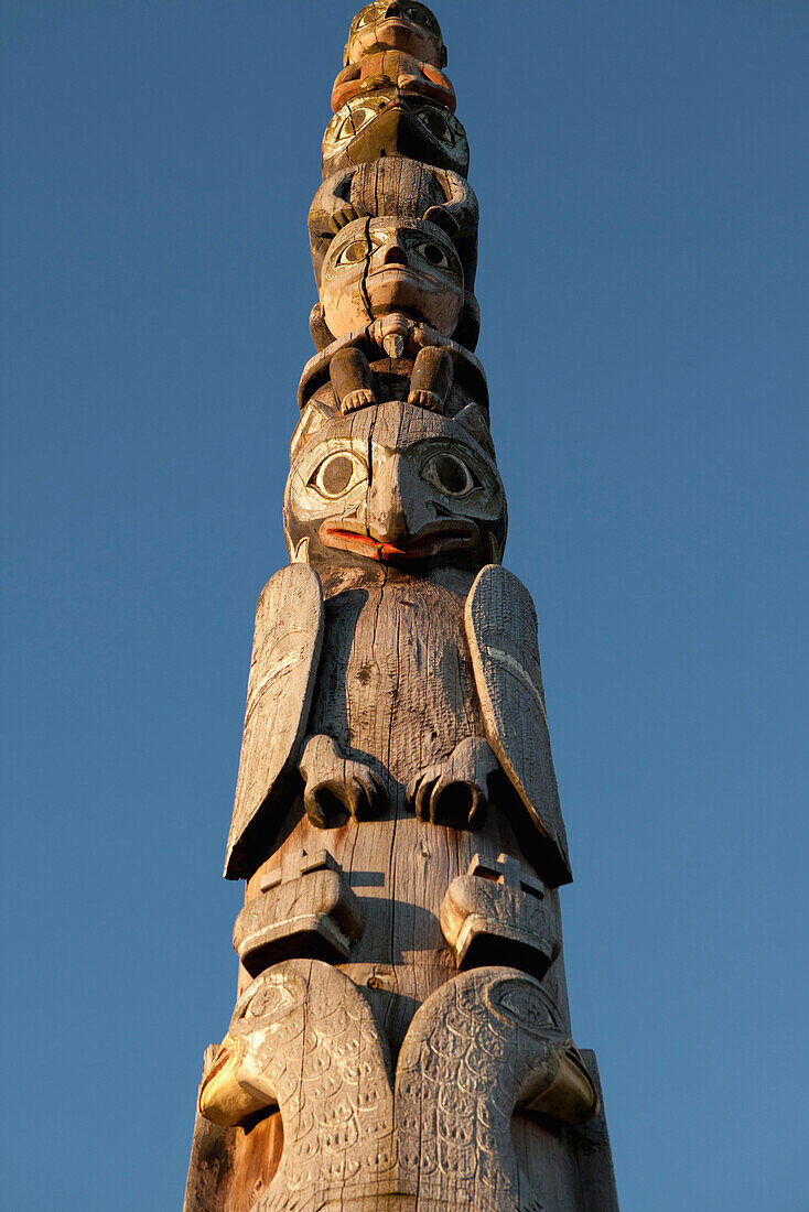 ALASKA, Sitka, details of an old totem pole that stands in the center of town on the edge of Sitka Harbor