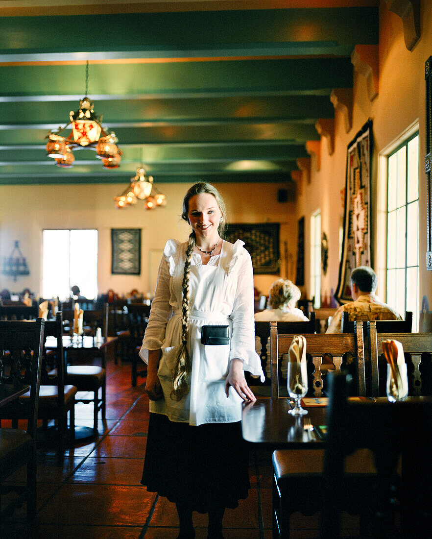 USA, Arizona, waitress in dining room of La Posada Hotel, Winslow
