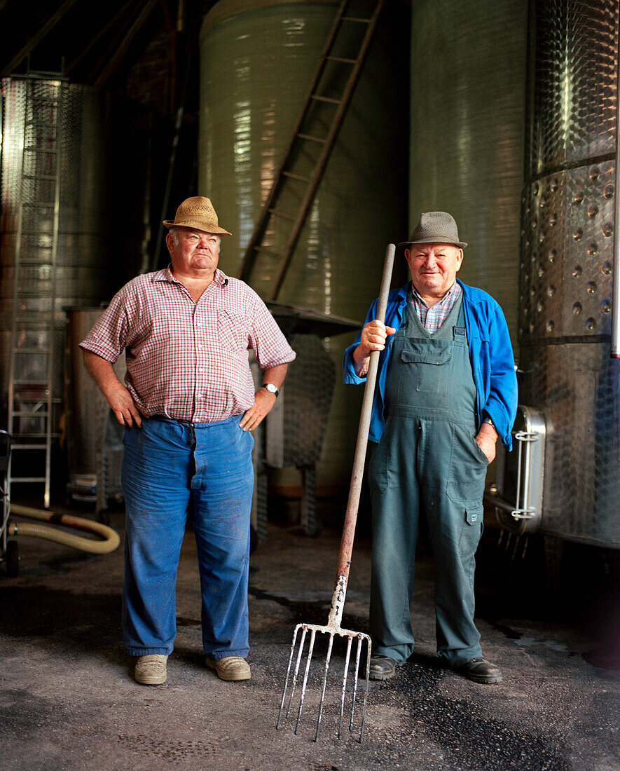 AUSTRIA, Joie, winemakers Willi Wetschka and Andre stand in front of their wine Vats, Golouborger Wine, Burgenland