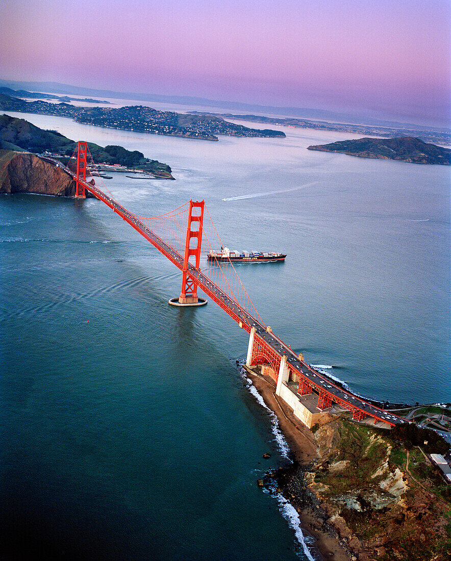 USA, San Francisco, an aerial view of a container ship passing under the Golden Gate Bridge, a view towards the Marin Headlands, Tiburon and Angel Island